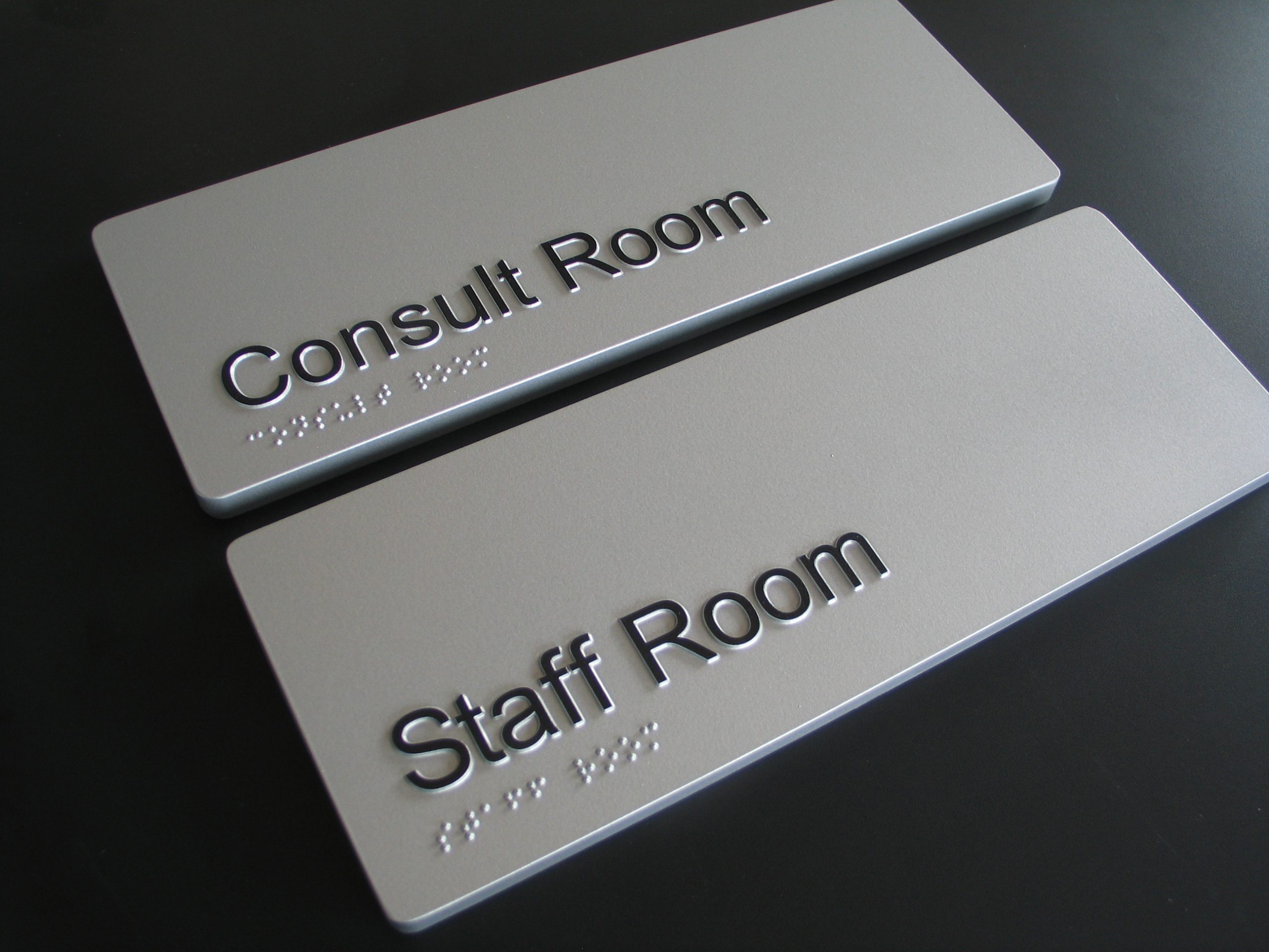 10mm thick moulded Acrylic Braille Signs, moulded from a single piece of acrylic with no parts fixed to the signs