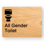 All Gender Toilet Braille Sign with a light woodgrain background & black Graphics