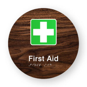 First Aid Braille Sign on a Tactile Printed Dark Woodgrain Acrylic Disk - Image 1