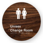 Unisex Change Room Braille Sign in Darkwoodgrain Acrylic. Circle shaped panel with white male & Female Symbol & Text that reads Unisex Change Room. White Braille Text is shown
