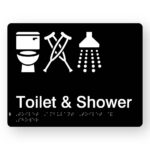 Toilet, Ambulant Toilet & Shower Braille Sign. A black panel with white tactile text & graphics including the following symbols, Toilet, Crutches & Shower.