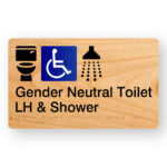 Gender Neutral Accessible Toilet LH & Shower Braille Sign in Woodgrain Acrylic. A Woodgrain colour panel with black raised tactile text & graphics including the Toilet, Accessible & Shower symbols.