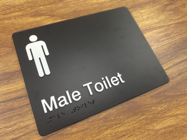 Male Toilet Black Moulded Acrylic Braille Sign. Black Sign panel white white Male Symbol & Text that reads Male Toilet