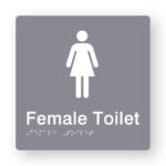 Female Toilet Braille Sign in Grey Tactile Printed Acrylic. Grey Sign panel with White female Symbol. White text reads Female Toilet. White Braille text is shown