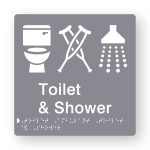 Toilet & Shower Braille Sign in Grey Tactile printed Acrylic. Grey Sign panel with white Toilet, Ambulant & Shower Symbol. White Text reads Toilet & Shower. White Braille Text is shown
