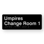 Umpires Change Room 1 Braille Sign inBlack Acrylic. Black Sign panel with white text that reads Umpires Change Room 1