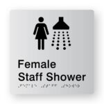 Female Staff Shower Braille Sign in Tactile Printed Silver Acrylic. Silver Sign panel with Female & Shower symbol. Black text reads Female Staff Shower. Black Braille Text is shown