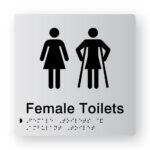 Female Toilet Braille Sign in Tactile Printed Silver Acrylic. Silver Sign panel with Black Female 7 female Ambulant Symbols. Black Text reads Female Toilets. Black Braille text is shown