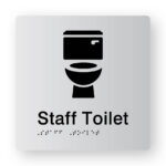 Staff Toilet Braille Sign in Tactile Printed Silver Acrylic. Silver Sign Panel with Black Toilet Symbol. Black text reads Staff Toilet. Black Braille text is shown