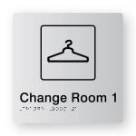 Change Room 1 Braille Sign in Tactile printed Silver Acrylic. Silver Sign panel with A Black coat hanger Symbol. Black text reads Change Room 1. Black Braille text is shown
