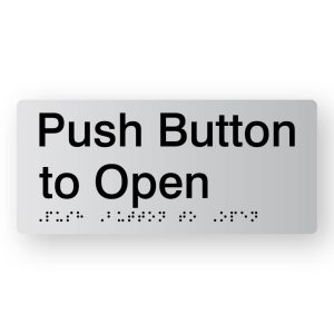 Push Button to Open Braille Sign in Tactile printed Silver Acrylic. Silver Sign Panel with Black Text that reads Push Button to Open. Black Braille text is shown