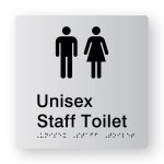 Unisex Staff Toilet Braille Sign in Tactile printed Silver Acrylic. Silver Sign panel with Black Male & Female Symbols. Black Text Reads Unisex Staff Toilet. Black Braille text is shown