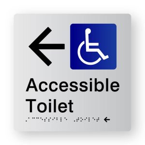 Accessible Toilet Braille Sign with Left Arrow, Tactile printed in Silver Acrylic. Silver Sign panel with Black Arrow & Blue & White Accessible Symbol. Black Text reads Accessible Toilet. Black Braille text is shown.