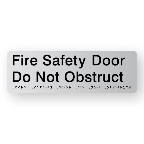 Fire Safety Door Do Not Obstruct Braille Sign in Tactile printed Silver Acrylic Fire Safety Door Do Not Obstruct Braille Sign in Tactile printed Silver Acrylic. Silver Sign panel with Black Text that reads Fire Safety Door Do Not Obstruct. Black Braille is shown