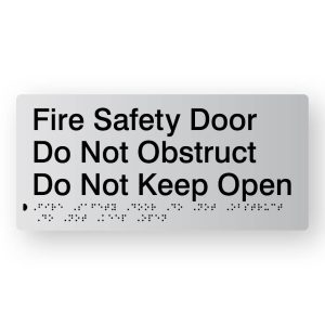 Fire Safety Door Do Not Obstruct Do Not Keep Open Braille Sign in Tactile printed Silver Acrylic. Silver Sign panel with Black Text that reads Fire Safety Door Do Not Obstruct Do Not Keep Open. Black Braille is shown