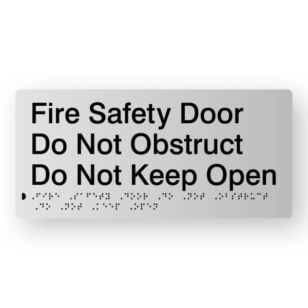 Fire Safety Door Do Not Obstruct Do Not Keep Open Braille Sign in Tactile printed Silver Acrylic. Silver Sign panel with Black Text that reads Fire Safety Door Do Not Obstruct Do Not Keep Open. Black Braille is shown