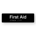 First Aid Braille Sign in Tactile printed Black Acrylic. Black Sign panel with White Text that reads First Aid. White Braille is shown