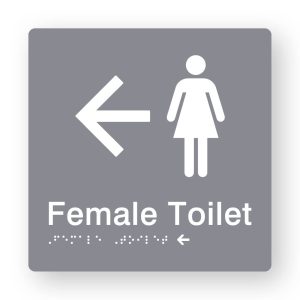 Female Toilet Braille Sign with Left Arrow in Tactile printed Grey Acrylic. Grey Sign panel with White Female Symbol & Left Arrow. White text reads Female Toilet. White Braille is shown
