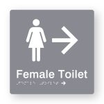 Female Toilet Braille Sign with Right Arrow in Tactile printed Grey Acrylic. Grey Sign panel with White Female Symbol & Right Arrow. White text reads Female Toilet. White Braille is shown