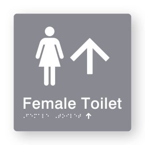 Female Toilet Braille Sign with Up Arrow in Tactile printed Grey Acrylic. Grey Sign panel with White Female Symbol & Up Arrow. White text reads Female Toilet. White Braille is shown