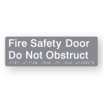 Fire Safety Door Do Not Obstruct Braille Sign in Tactile printed Grey Acrylic. Grey Sign panel with White Text that reads Fire Safety Door Do Not Obstruct. White Braille is shown