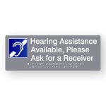 Hearing Assistance Available Braille Sign in Tactile Printed Grey Acrylic. Grey Sign panel with Blue & White Hearing Symbol. White text reads Hearing Assistance Available Please Ask for a receiver. White Braille text is shown