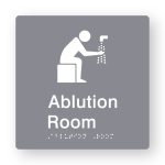 Ablution Room Braille Sign in Tactile printed Grey Acrylic. grey Sign panel with white Ablution Symbol. White Text reads Ablution Room. White Braille Text is shown