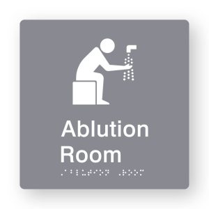 Ablution Room Braille Sign in Tactile printed Grey Acrylic. grey Sign panel with white Ablution Symbol. White Text reads Ablution Room. White Braille Text is shown